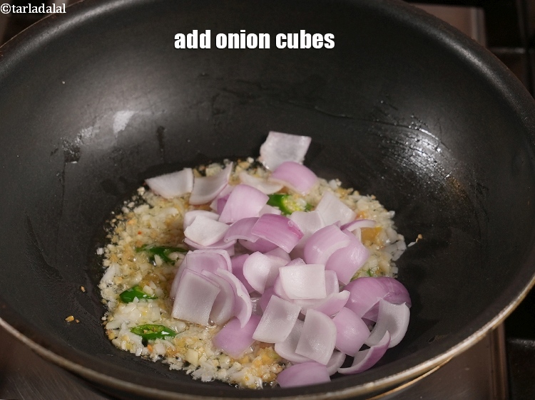 Step 28 – Add &frac12; cup <a href="https://www.tarladalal.com/glossary-onion-cubes-732i">onion cubes</a>.