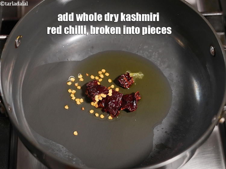 Step 28 – Add 1 <a href="https://www.tarladalal.com/glossary-whole-dry-kashmiri-red-chillies-kashmiri-mirch-kashmiri-lal-mirch-332i">whole dry kashmiri red chilli</a>, broken into pieces.