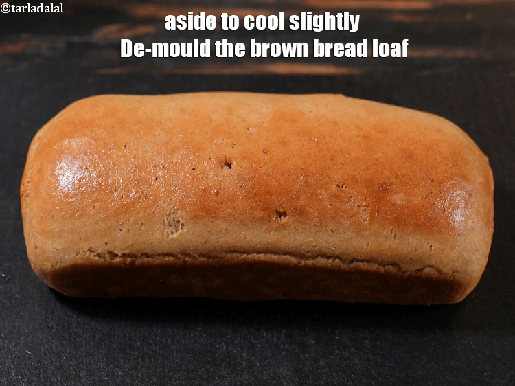 Step 33 – Keep the <strong>brown bread loaf</strong> made using instant dry yeast aside to cool slightly De-mould …