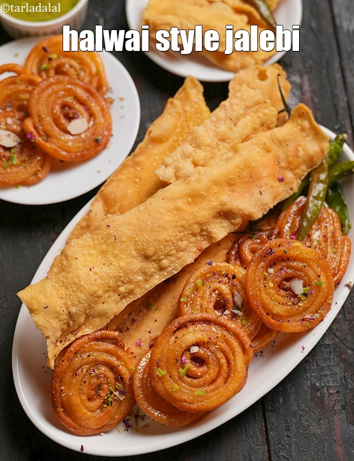 Step 29 – Serve <strong>homemade crispy Jalebi </strong>immediately garnish with almond slivers, pista slivers and rose petals.