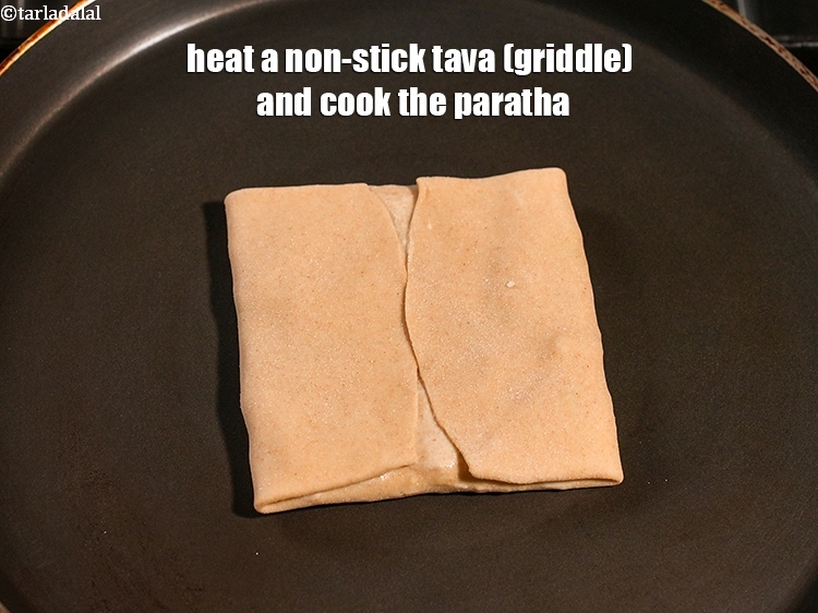 Step 28 – Heat a non-stick tava (griddle) and cook the paratha.