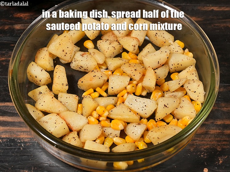 Step 28 – In a baking dish, spread half of the sauteed potato and corn mixture.