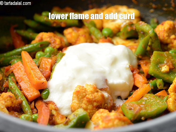 Step 28 – Lower the flame and add &frac12; cup curd.