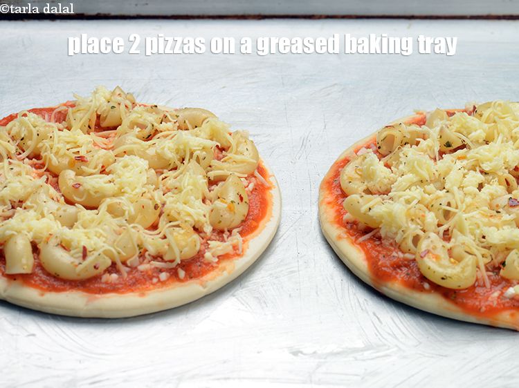 Step 30 – Place 2 pizzas on a greased baking tray.