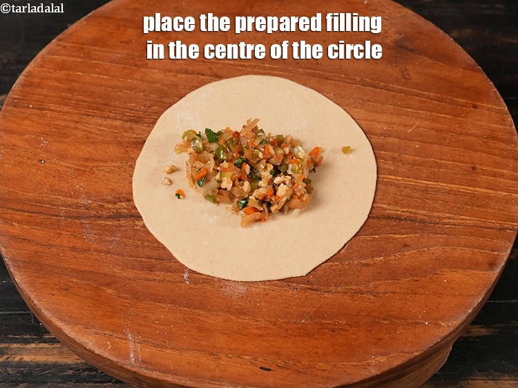 Step 28 – Place 1 tbsp of the prepared filling in the centre of the circle.