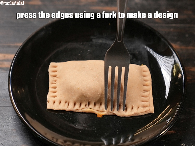 Step 28 – Press the edges using a fork to make a design.