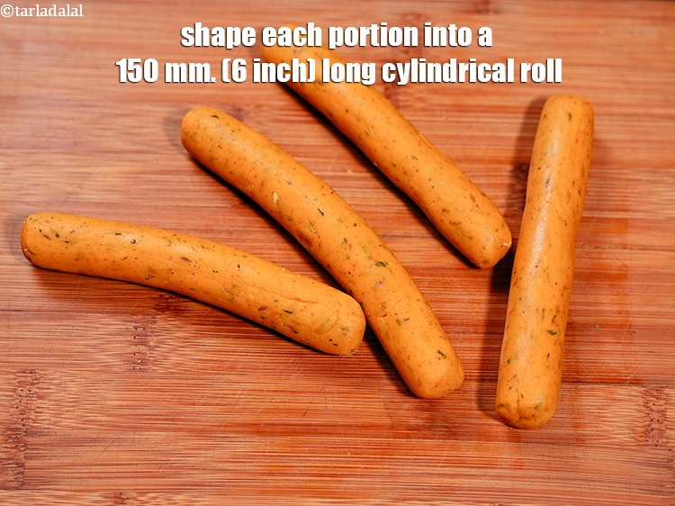 Step 28 – Shape each portion into a 150 mm. (6 inch) long cylindrical roll.