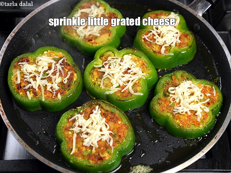 Step 28 – Lower the flame and sprinkle little grated cheese on each cooked roundel.