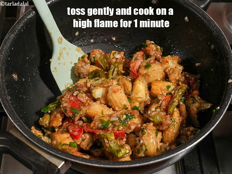 Step 28 – Toss gently and cook on a high flame for 1 minute, while tossing occasionally.