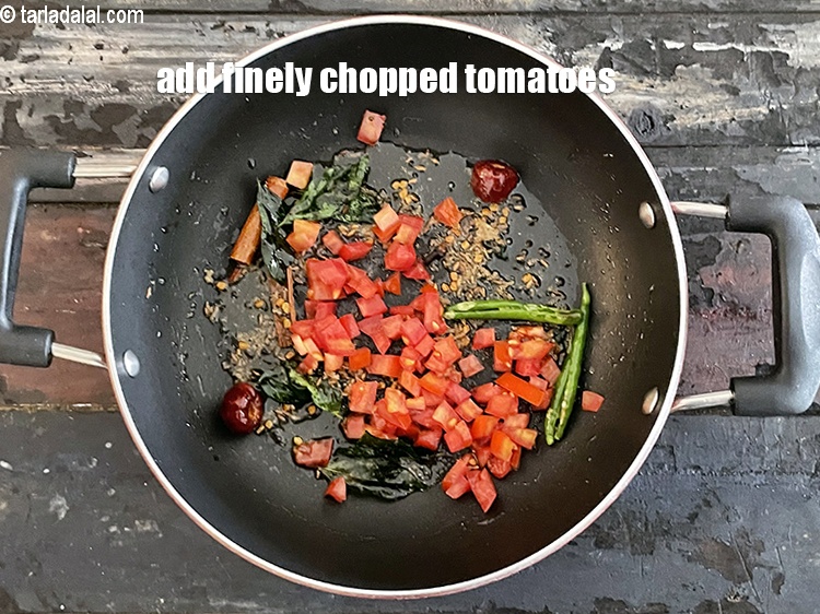 Step 28 – <p>Add 1/4 cup finely <a href="https://www.tarladalal.com/glossary-chopped-tomatoes-779i"><strong>chopped tomatoes</strong></a><strong>.</strong></p>