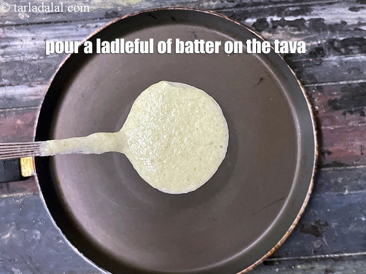 Step 29 – Pour a ladleful of batter on a hot non-stick tava (griddle).