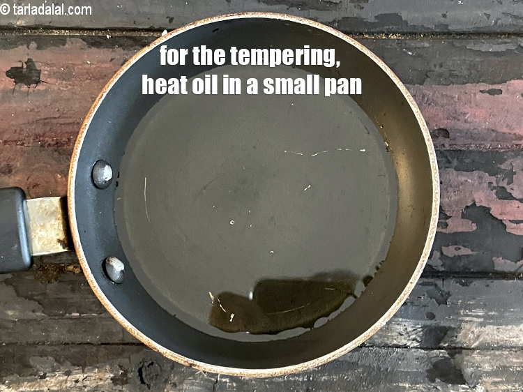 Step 28 – <meta charset="UTF-8" /> For the&nbsp;<strong>tempering of green peas dhoklas</strong>, heat 1 1/2 tablespoons&nbsp;oil in small …