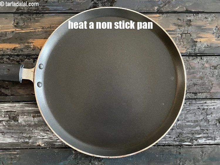 Step 29 – <meta charset="UTF-8" />Heat a non-stick tava (griddle).