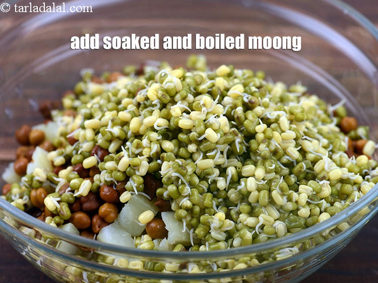 Step 31 – Add 1 cup soaked and <a href="https://www.tarladalal.com/glossary-boiled-moong-1355i">boiled moong (whole green gram)</a>.