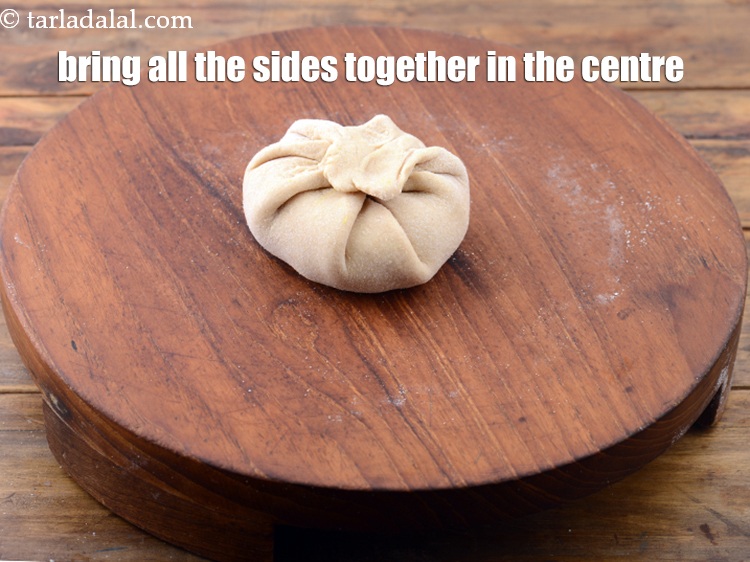 Step 29 – Bring all the sides together in the centre. Seal the dough ball tightly.