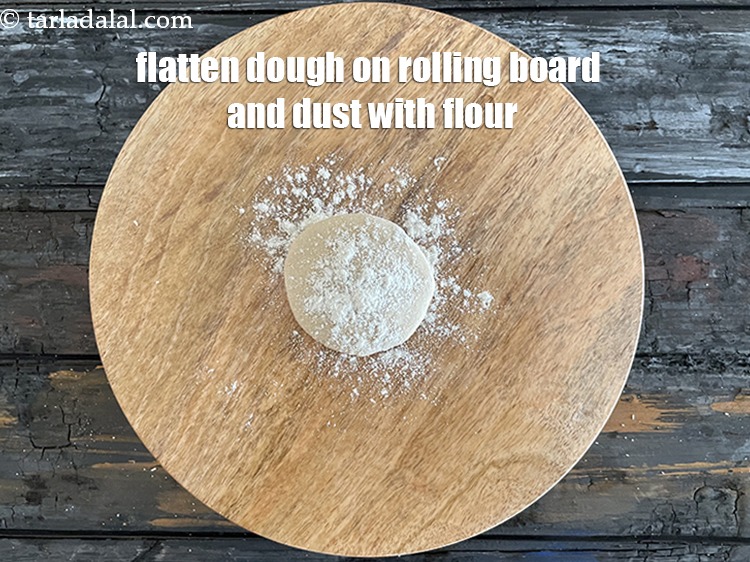 Step 29 – <meta charset="UTF-8" /> Flatten the dough&nbsp;on the rolling board and dust with flour.