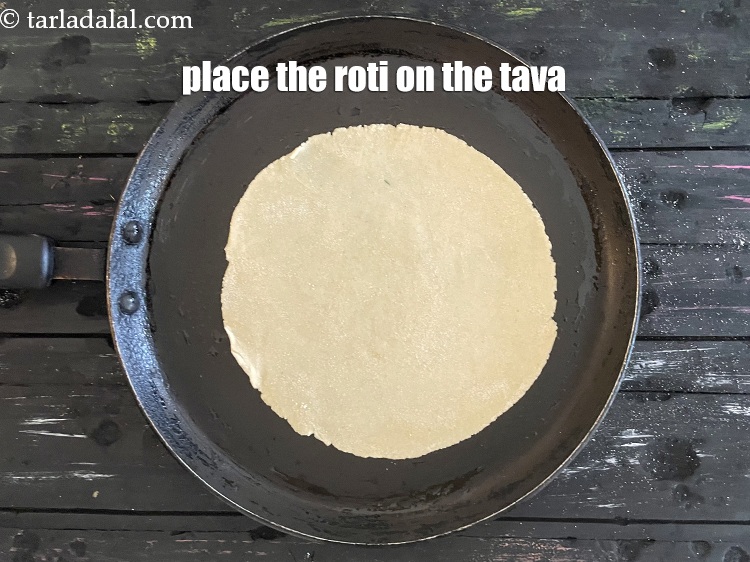 Step 30 – Place the roti on a greased hot non-stick tava (griddle).