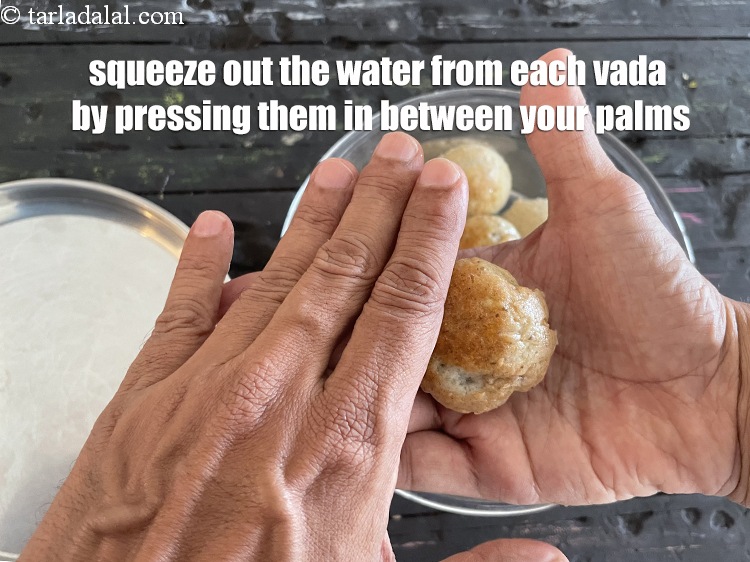 Step 28 – <meta charset="UTF-8" />Thereafter, squeeze out all the water from each vada by pressing them in …