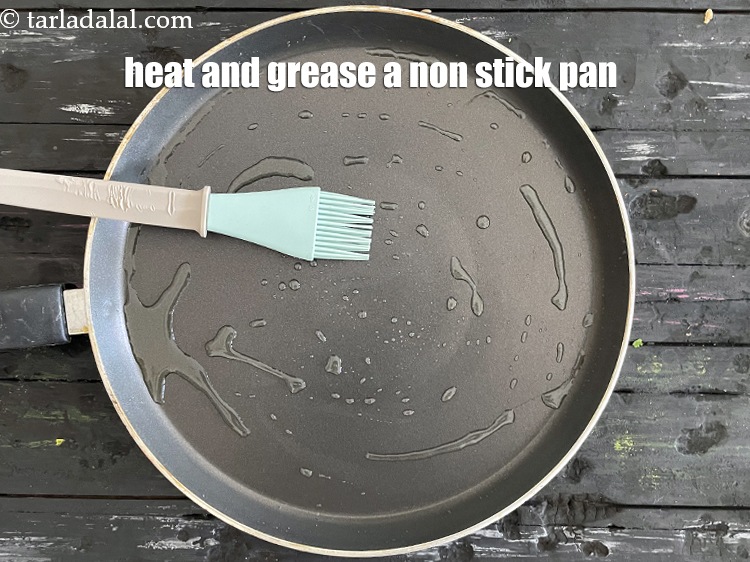 Step 29 – <meta charset="UTF-8" />Heat and grease a non-stick tava (griddle) using &frac12; tsp of oil.&nbsp;