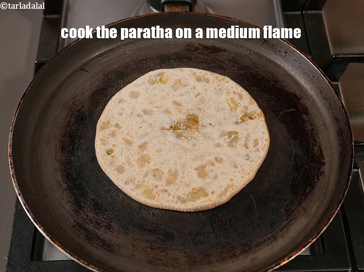 Step 28 – Cook the paratha on a medium flame.