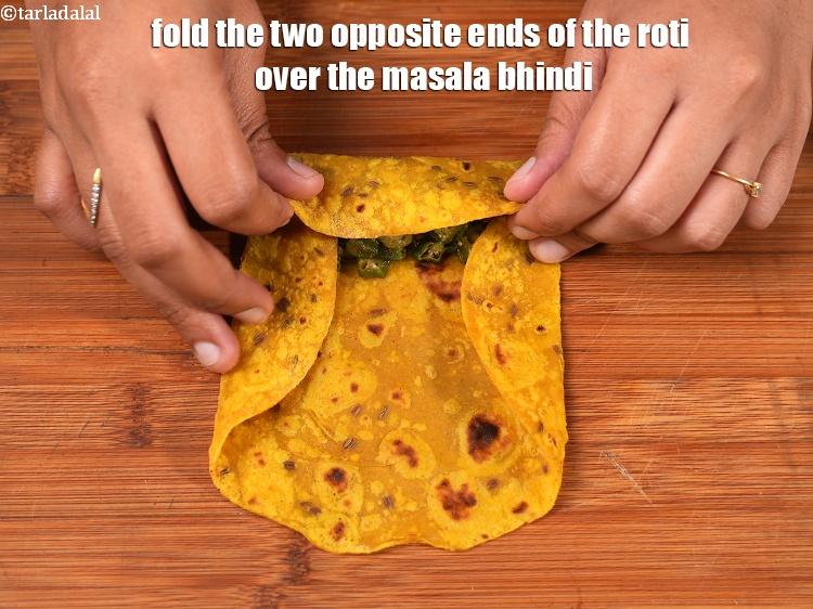 Step 29 – Fold the two opposite ends of the roti over the masala bhindi.