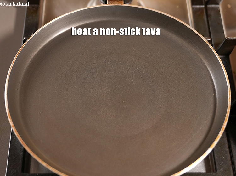 Step 28 – <meta charset="UTF-8" />Heat a non-stick tava (griddle).