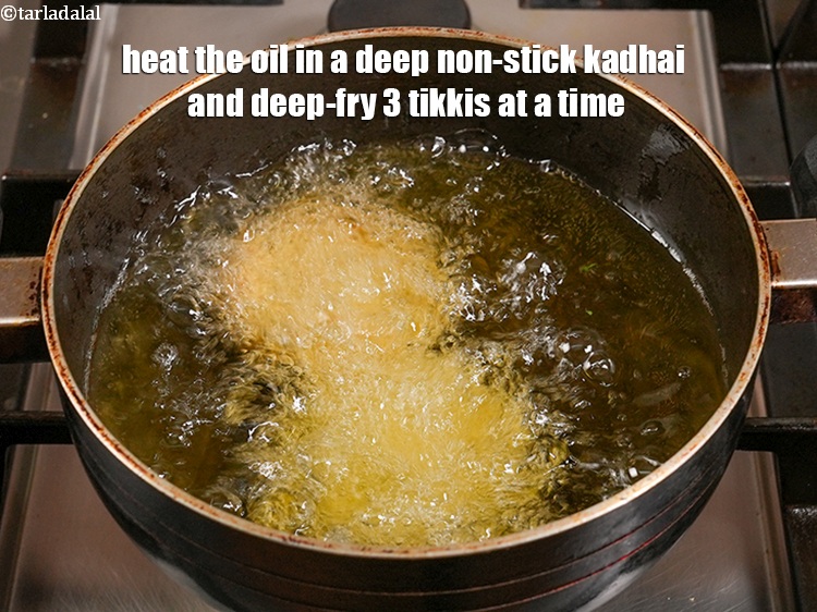 Step 30 – Heat the oil in a deep non-stick kadhai and deep-fry 3 tikkis at a time