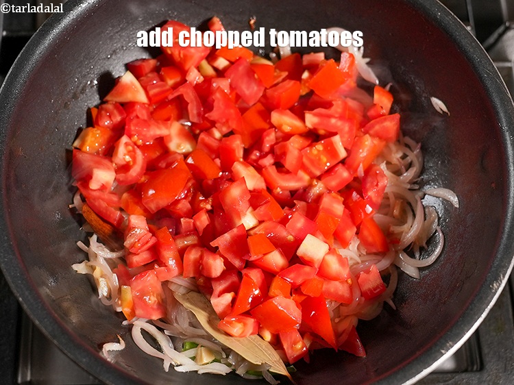 Step 30 – Add 1&frac12; cups of&nbsp;<a href="https://www.tarladalal.com/glossary-chopped-tomatoes-779i">chopped tomatoes</a>.