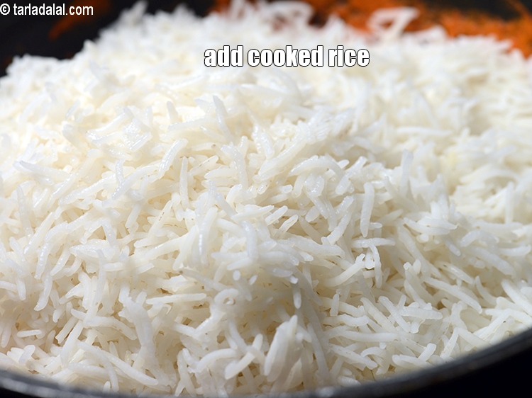 Step 30 – Add 3 cups <a href="https://www.tarladalal.com/glossary-soaked-and-cooked-long-grain-rice--1904i">cooked long grained rice (basmati chawal)</a>.
