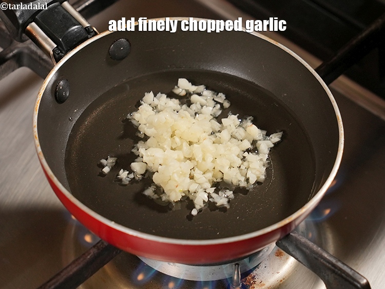 Step 29 – Add 1 tbsp finely <a href="https://www.tarladalal.com/glossary-chopped-garlic-790i">chopped garlic (lehsun)</a>.&nbsp;