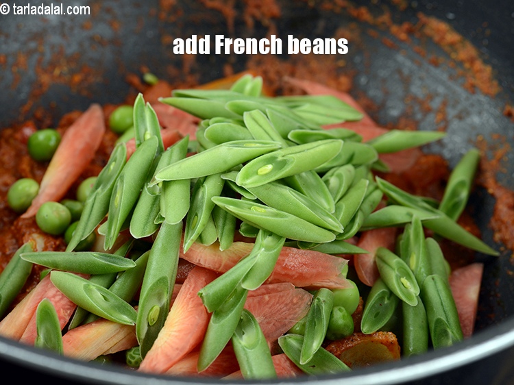 Step 30 – Add &frac12; cup&nbsp;<a href="https://www.tarladalal.com/glossary-diagonally-cut-french-beans-2461i">diagonally cut french beans</a>.
