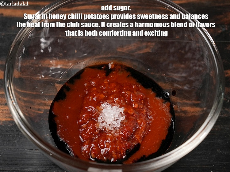 Step 28 – Add &frac12; tsp <a href="https://www.tarladalal.com/glossary-sugar-chini-shakkar-278i">sugar</a>. Sugar in honey chilli potatoes provides sweetness and balances the …