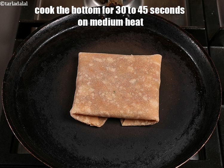 Step 49 – Place the uncooked&nbsp;<strong>rajma cheese paratha&nbsp;</strong>over it. <u><em>The flat surface of the paratha should be facing …