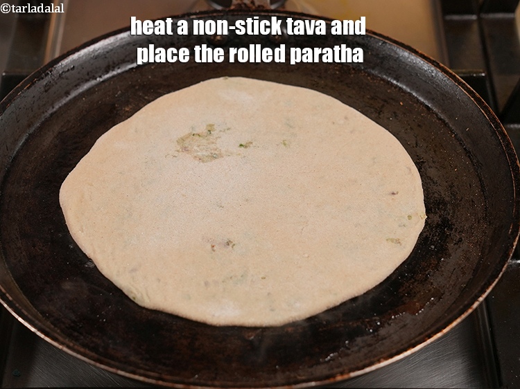 Step 29 – Heat a non-stick tava (griddle) and place the rolled paratha.