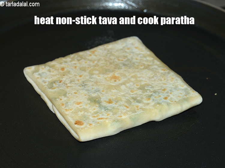 Step 31 – Heat a non-stick tava (griddle) and cook the paratha.