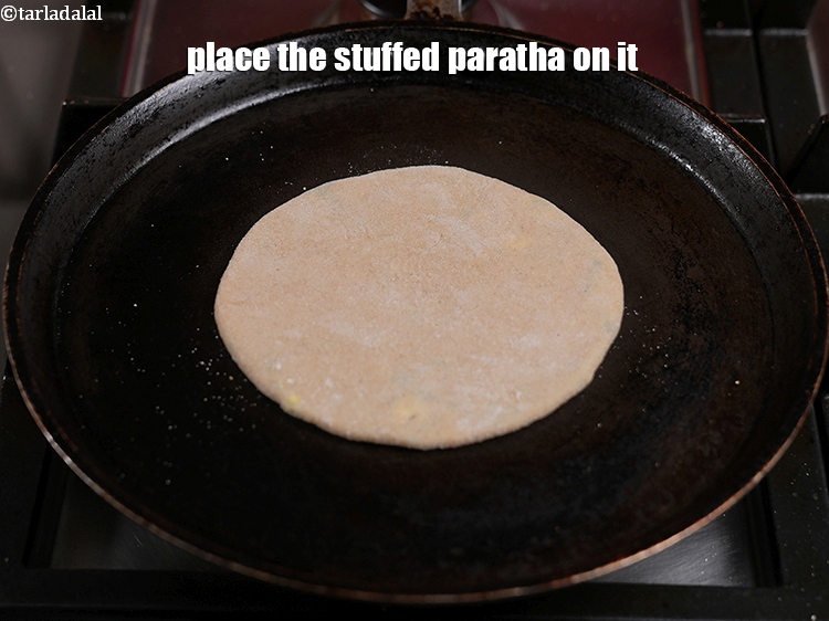 Step 32 – Place the stuffed paratha on it.