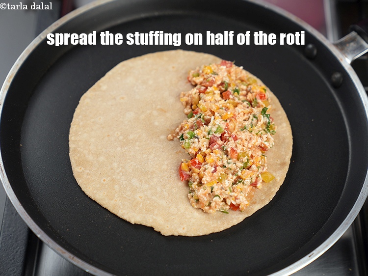 Step 31 – Spread one portion of the stuffing on half of the roti.