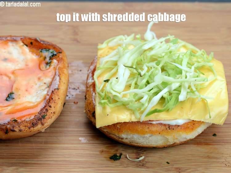 Step 29 – Top it with 2 tbsp <a href="https://www.tarladalal.com/glossary-shredded-cabbage-763i">shredded cabbage</a>.
