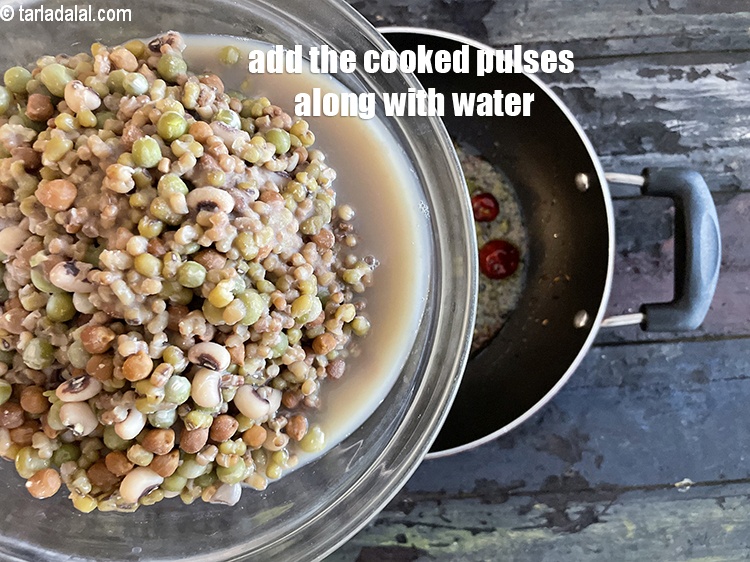 Step 29 – Add the cooked pulses along with the water.