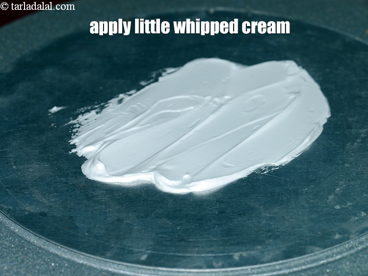 Step 31 – Apply little whipped cream on the surface of the cake board.