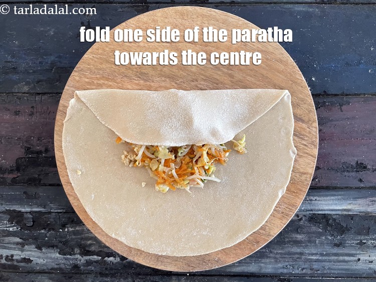 Step 31 – Fold one side of the roti to the centre.