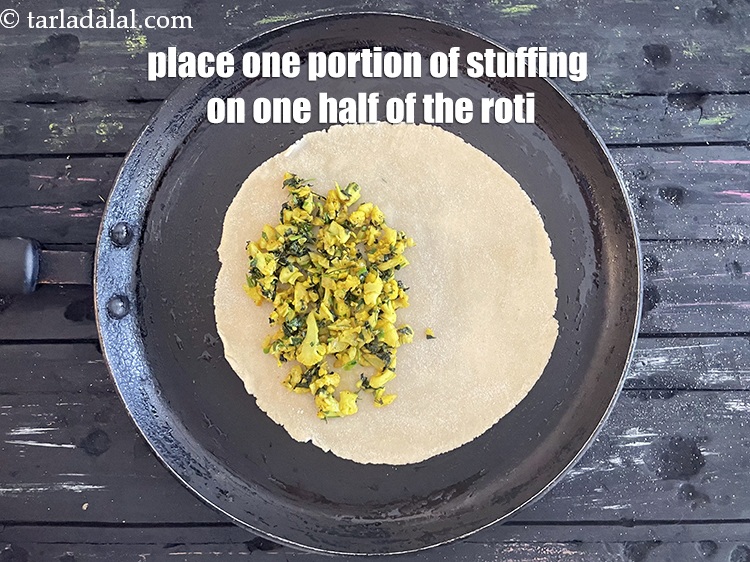 Step 31 – Place 1 portion of the stuffing on one half of the roti.