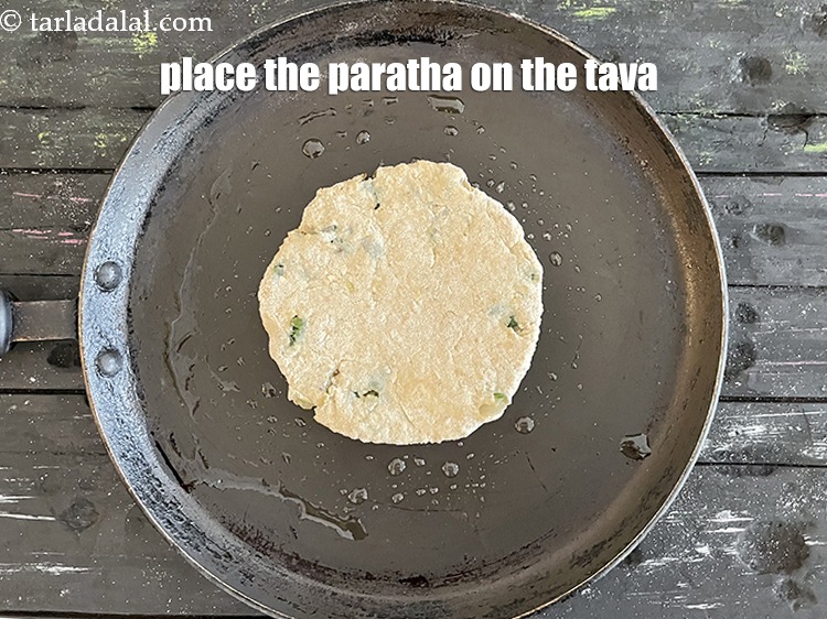 Step 31 – Place the paratha on the tava.