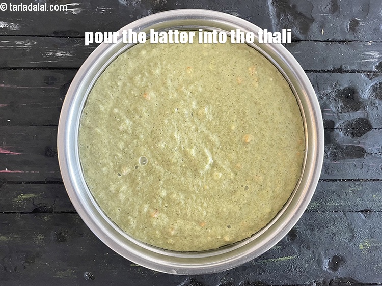 Step 29 – <meta charset="UTF-8" />Pour the mixture into a greased 175 mm. (7&rdquo;) diameter thali.