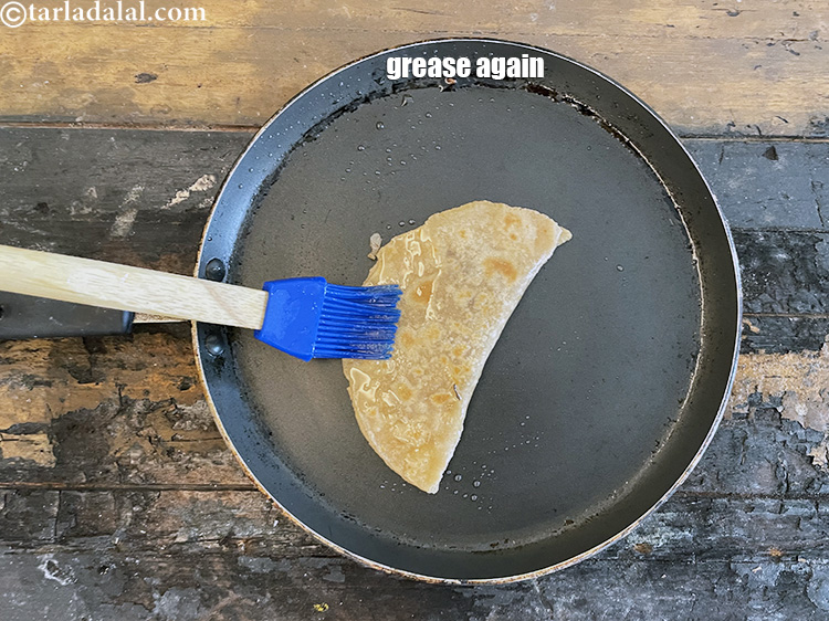 Step 30 – Again grease the roti and cook for 10 seconds.