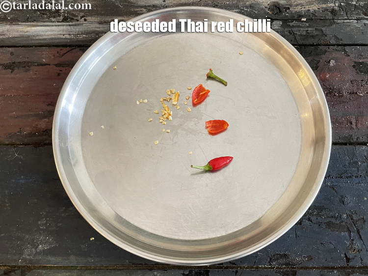 Step 15 – Slice the top off the Thai chilli and cut in half. Remove and discard the …