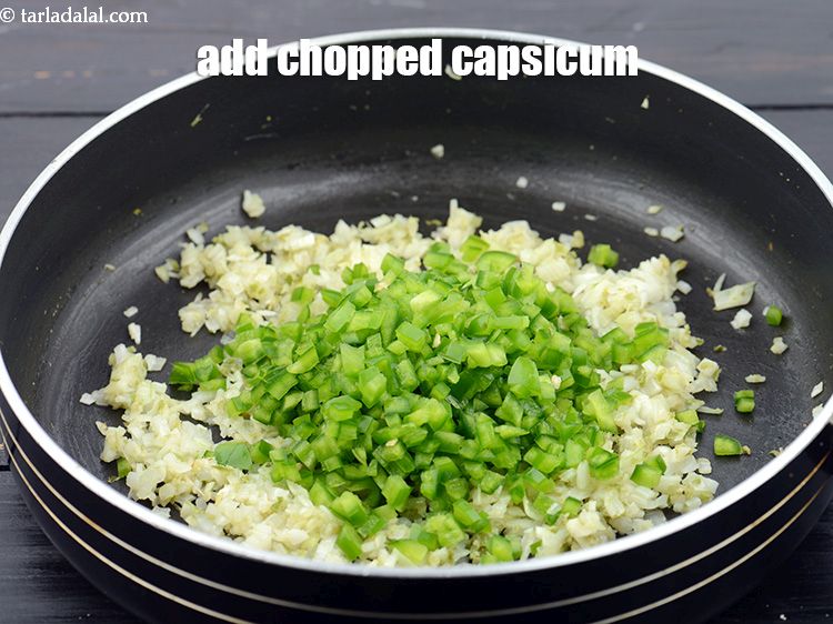 Step 30 – Add 1/2 cup&nbsp;finely&nbsp;<a href="https://www.tarladalal.com/glossary-chopped-capsicum-164i">chopped capsicum</a>.&nbsp;