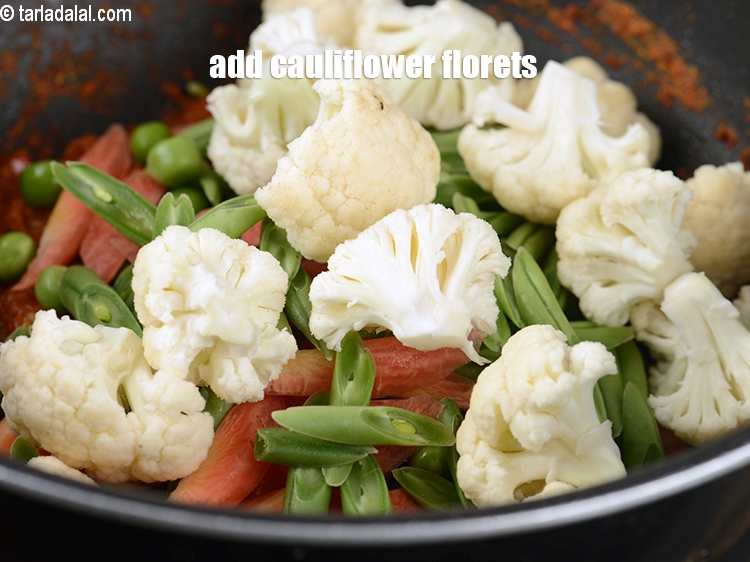 Step 31 – Add 1 cup <a href="https://www.tarladalal.com/glossary-cauliflower-florets-753i">cauliflower florets</a>.