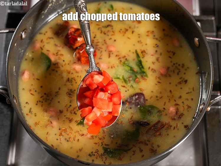 Step 30 – Add &frac14; cup <a href="https://www.tarladalal.com/glossary-chopped-tomatoes-779i">chopped tomatoes</a>.