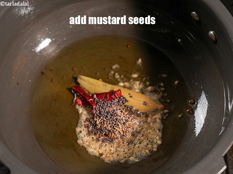 Step 30 – Add &frac12; tsp <a href="https://www.tarladalal.com/glossary-mustard-seeds-sarson-rai-sarson-ke-beej-525i">mustard seeds ( rai / sarson)</a>.